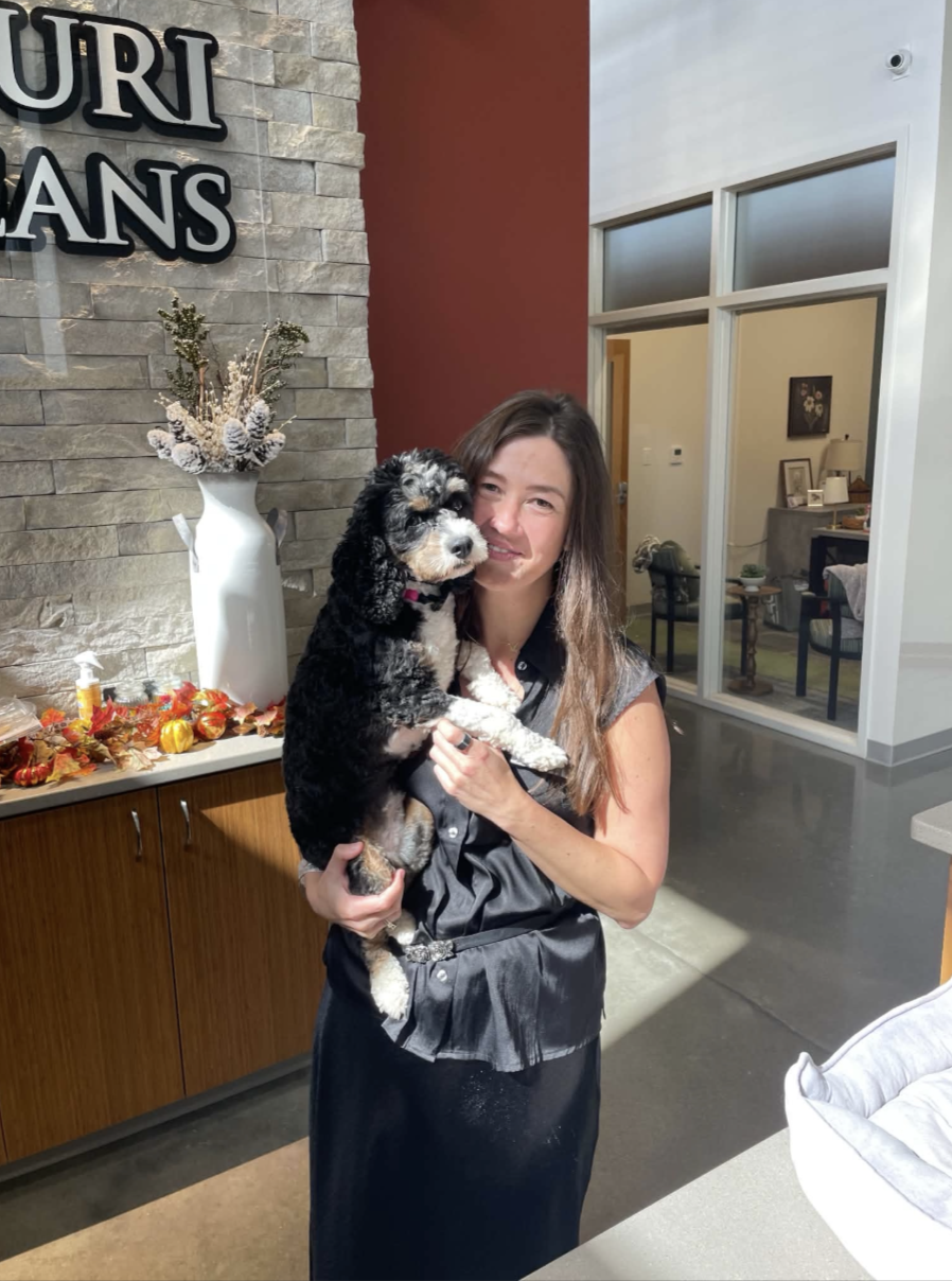 Katya Ponomarenko with Winnie Meyer, the dog greeting visitors at the Missouri Soybean Association